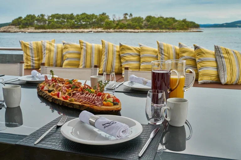 Alfresco dining table aboard Rara Avis