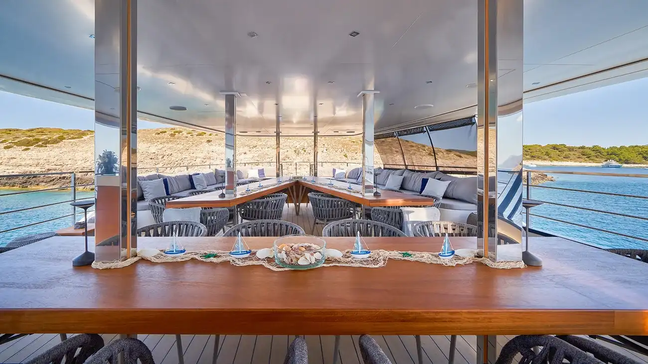 Outdoor dining and lounge area aboard ARGO luxury yacht
