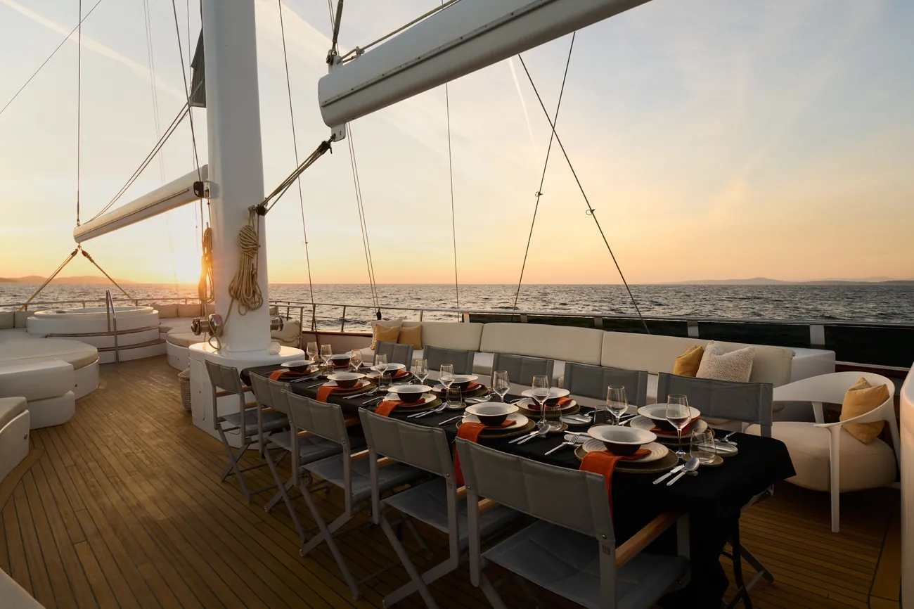 Outdoor dining area aboard Lady Gita at sunset in Croatia
